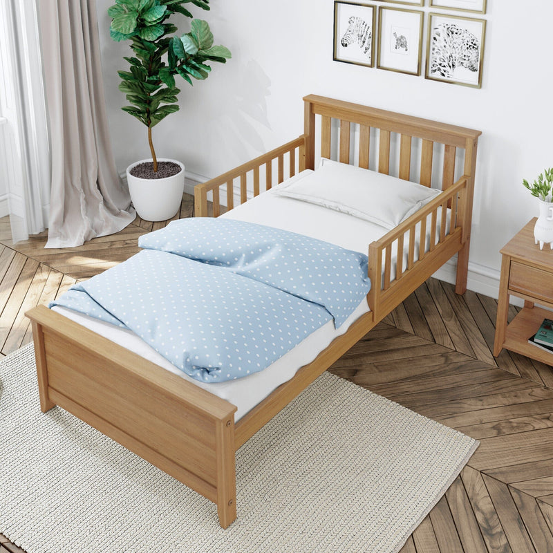 Children's wooden single bed with light blue polka-dot duvet and white pillow in a Scandinavian-style bedroom with potted fiddle leaf fig, animal wall art, cream rug, and herringbone hardwood floor