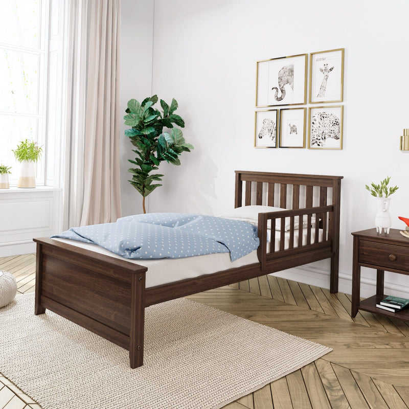 Wooden toddler bed with blue bedding in modern bedroom setting.