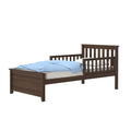 Dark brown wooden toddler transition bed with safety side rail and blue polka-dot comforter, ideal for a child's bedroom