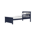 Modern navy blue wooden twin bed frame with slatted headboard, white mattress and gray textured pillows — kids bedroom furniture