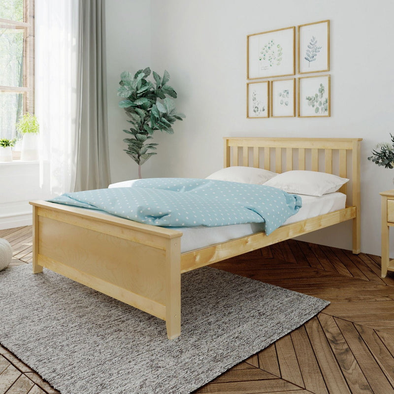 Natural wood bed frame with blue polka dot duvet in cozy minimalist bedroom.