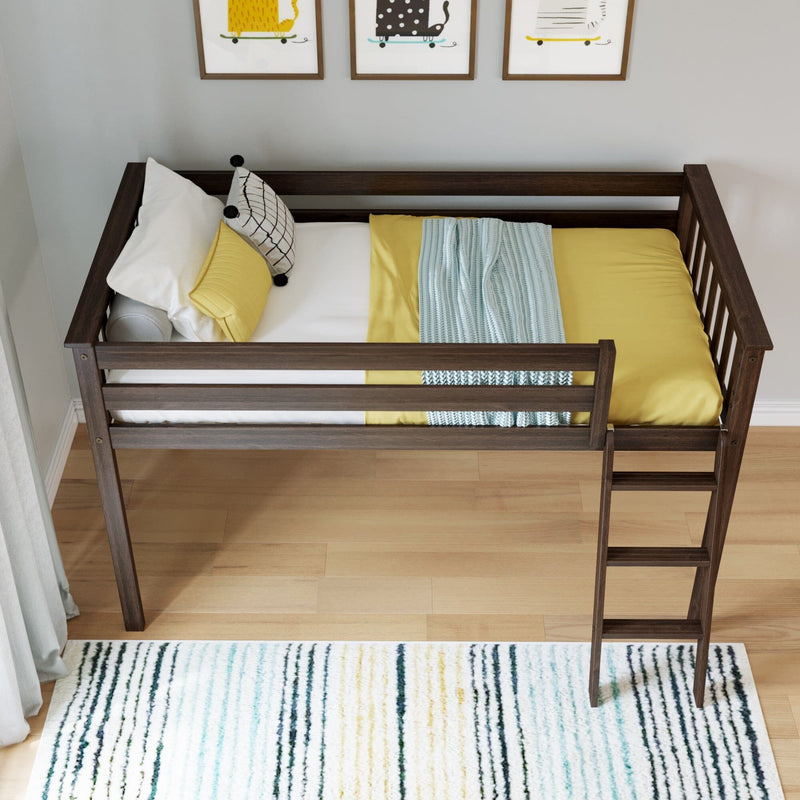 Overhead view of a dark wood toddler loft bed with yellow bedding, patterned pillows and ladder in a modern kids bedroom with framed animal prints and a striped rug