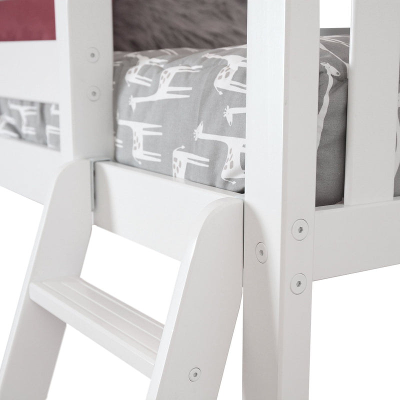 White wooden ladder leading to a children’s bed with giraffe-patterned bedding.