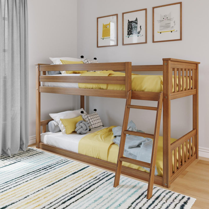 Wooden bunk bed with yellow bedding in a stylish children's room featuring framed cat art and striped rug.