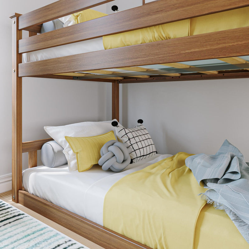 Two-tier wooden bunk bed with yellow and white bedding and decorative pillows in a modern bedroom setup.