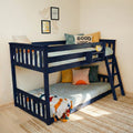 Navy blue bunk bed in kids' bedroom with ladder, "Good Vibes" pillow, colorful cushions, woven rug and playful wall art