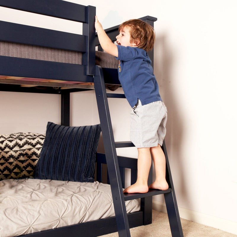 Child climbing a bunk bed ladder safely indoors.