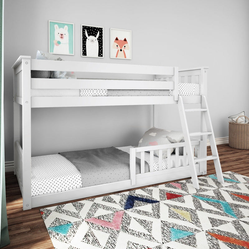 White wooden bunk bed with colorful geometric rug and animal artwork in a modern kids' bedroom.