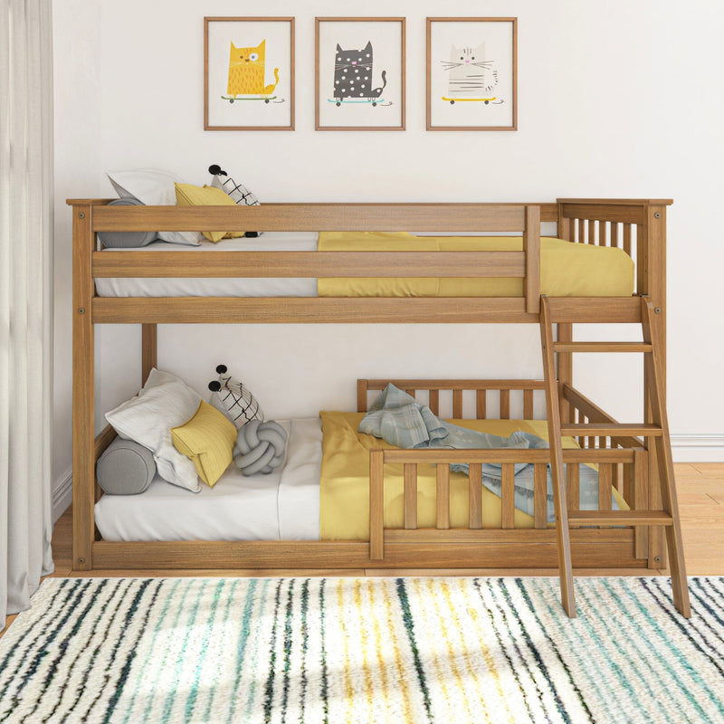 Modern wooden twin-over-twin bunk bed with ladder in a children's bedroom, yellow bedding, decorative pillows, cat wall art and striped rug