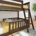 Dark walnut wood twin-over-full bunk bed with ladder, yellow bedding and light blue throw in a modern children's bedroom with striped rug and potted plant