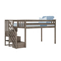 Loft bed with stairs and built-in storage – gray weathered wooden raised platform with guardrail, blue bedding and pillows, space-saving kids' bedroom furniture