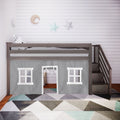 Gray wooden kids loft bed with fabric playhouse curtain and stairs, moon and star wall decor and geometric area rug