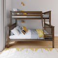 Solid wood bunk bed with ladder in modern kids' bedroom, grey and yellow bedding, brass wall sconces, white curtains and patterned rug