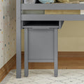Gray storage furniture under loft bed with polka dot wall decor and geometric rug.
