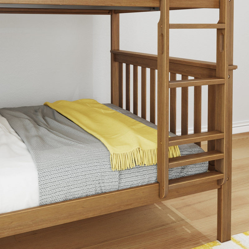 Close-up of solid wood bunk bed ladder and guardrail with gray knit blanket and yellow throw on mattress, natural wood finish