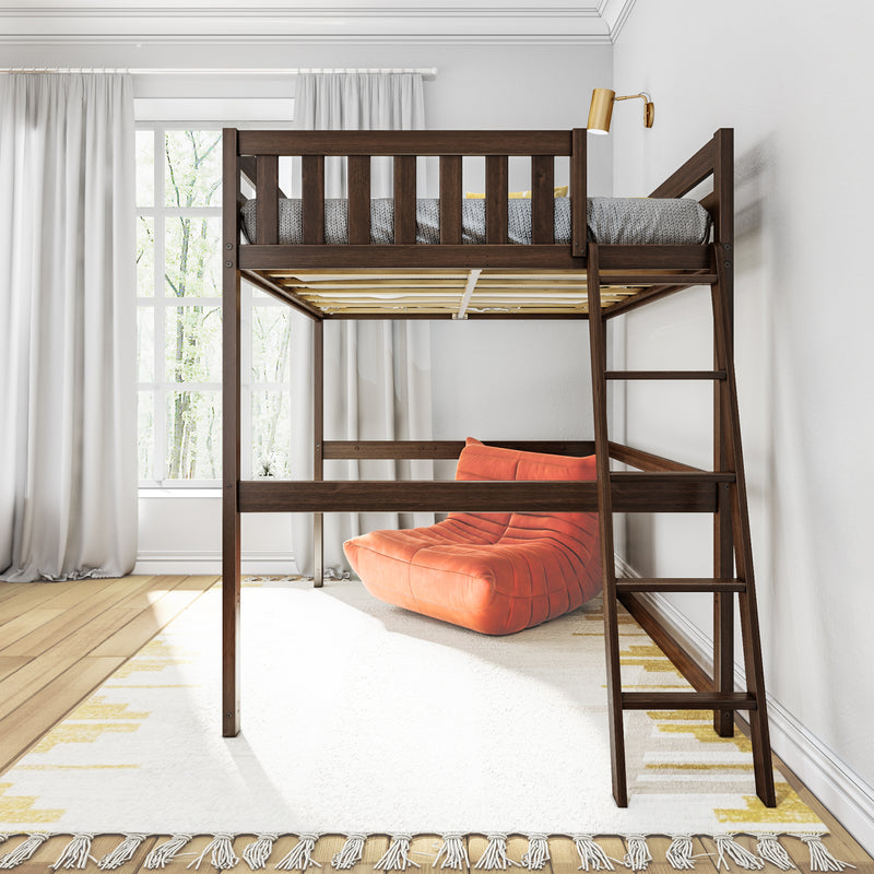 Space-saving dark wood loft bed with ladder and gray knit bedding above orange lounge chair in a bright minimalist bedroom with large window
