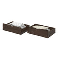 Set of two dark brown wooden underbed storage drawers with slide-out handles holding pillows and folded linens, space-saving bedroom organization and linen storage.