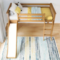 Modern wooden kids loft bed with slide and ladder, yellow bedding, decorative pillows and striped rug in bright children's bedroom