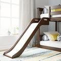 Modern wooden kids bunk bed with slide in bright nursery — white bedding, yellow accent pillows, window plants and striped rug