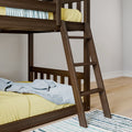 Dark walnut wooden bunk bed with ladder, yellow mattress and blue throw blanket on hardwood floor with striped rug