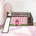 Pink girls loft bed with slide and wooden stairs, playhouse curtain and canopy, floral wall art and pink rug in modern children's bedroom
