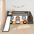 Dark wood kids loft bed with slide and stairs and camper-themed playhouse tent with orange and yellow accents, flower pillows and bunting on white shiplap wall in bright children's bedroom