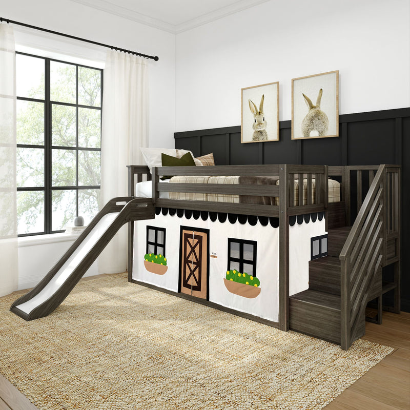 Kids loft bed with slide and cottage theme, featuring dark wooden stairs, decorative curtains, and bunny artwork in a bright bedroom.