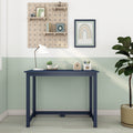 Navy blue children's desk in pastel mint nursery with pegboard shelves, white desk lamp, framed rainbow art and potted plant