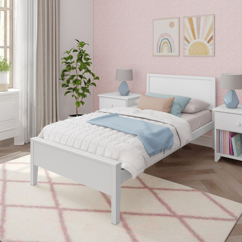 Modern white bedroom with twin bed, pink geometric wallpaper, cozy bedding, potted plant, and stylish decor.