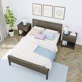 Cozy modern bedroom decor with dark wood bed frame, quilted white duvet, pastel pillows, matching nightstands with blue geometric lamps, potted plant, framed wall art, light blue patterned wallpaper, herringbone hardwood floor