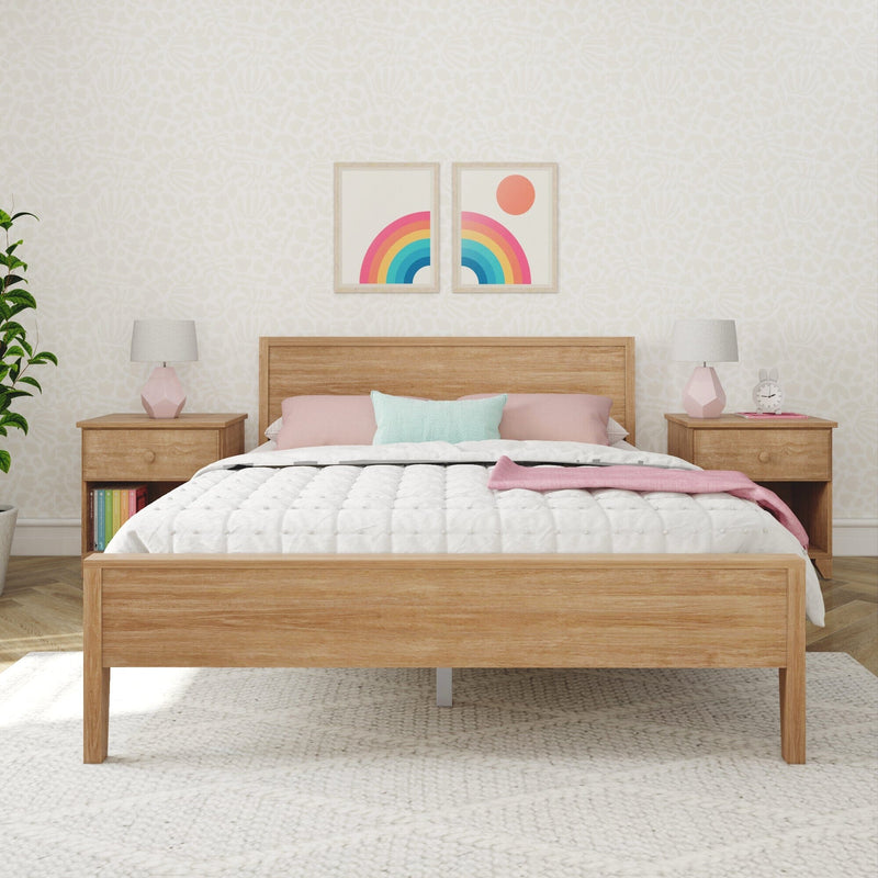 Minimalist bedroom with wooden bed frame, colorful throw pillows, and modern decor accents.