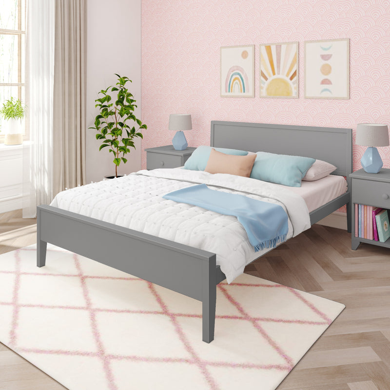 Modern pastel pink bedroom with scallop-pattern wallpaper, gray wood bed frame, bedside lamps, pastel rainbow wall art and potted plant