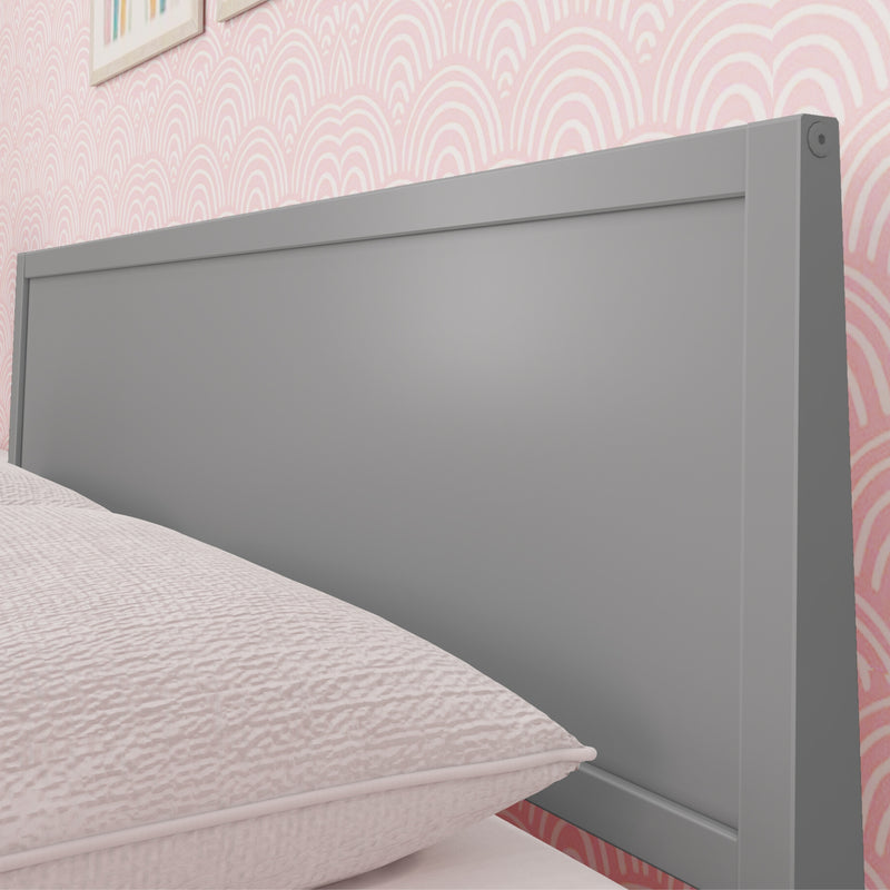 Modern gray wooden headboard with blush pink textured bedding and scallop-patterned pink wallpaper in a contemporary bedroom