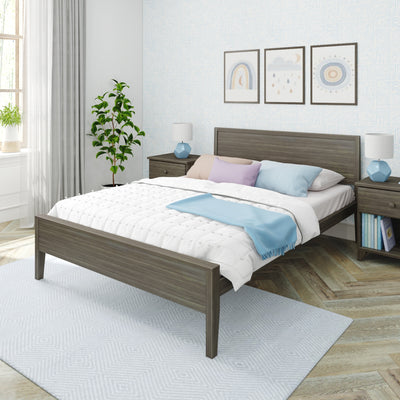 Modern cozy bedroom interior with gray wood bed frame, white quilt and pastel pillows, blue throw, matching nightstands and lamps, green potted plant, framed wall art and textured wallpaper by a sunlit window