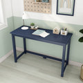 Navy blue desk in small home office — minimalist study desk with white lamp, succulent, notebook, wooden house decor and pencil holder against mint green half-wall, pegboard shelf and framed wall art on light wood floor