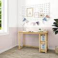 Light wood children's study desk with open shelves and storage bins in pink-and-white nursery, pegboard gallery wall with framed rainbow prints, bunting, desk lamp, alarm clock and potted plant