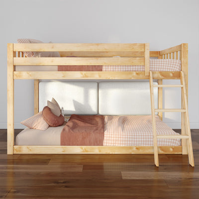 Solid wood loft bunk bed with ladder and pink gingham bedding in a modern kids' bedroom, cozy pillows and wooden floor