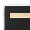 Close-up of upholstered headboard corner with white textured fabric trim, black backing and a wooden mounting plate secured by a screw