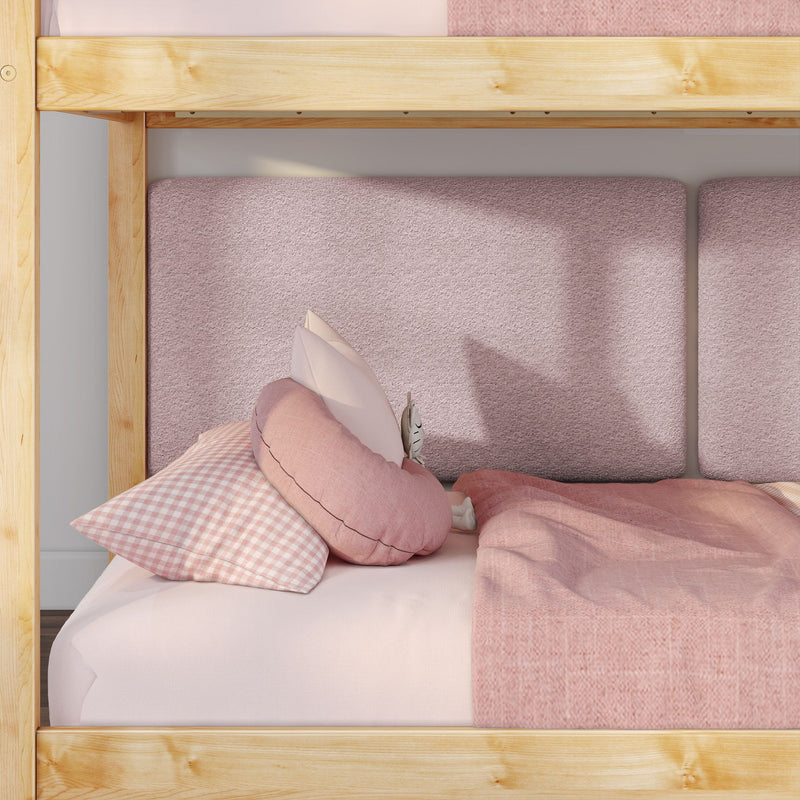 Wooden bunk bed with soft pink bedding, textured blush headboard panels, gingham pillow and decorative round cushions for a cozy children's bedroom