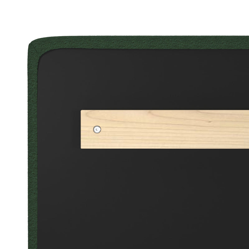Close-up of dark green textured upholstered headboard corner with black backing, light wood mounting bracket and visible screw