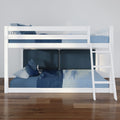 White wooden bunk bed with ladder and blue plaid bedding in modern kids' bedroom on polished hardwood floor