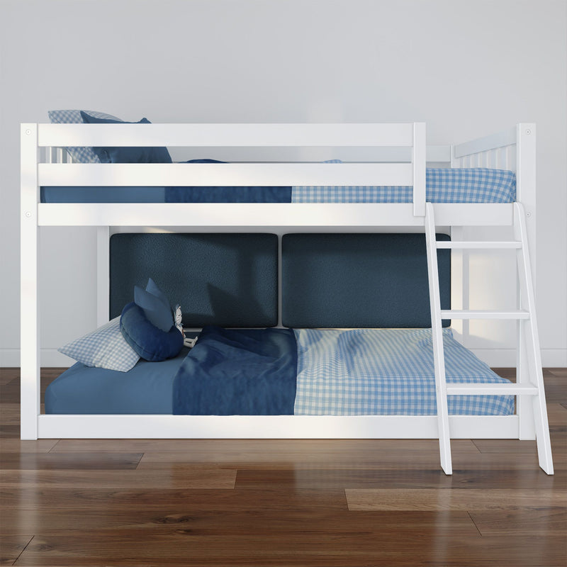 White wooden bunk bed with ladder and blue plaid bedding in modern kids' bedroom on polished hardwood floor