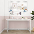 White kids study desk in a pastel pink nursery with pegboard gallery wall, bunting, desk lamp, alarm clock, succulent and birdhouse — modern minimalist children's room decor
