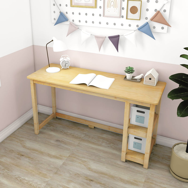 Light wood study desk in pastel pink and white bedroom with lamp, open notebook, alarm clock, succulent, decorative bunting and storage boxes
