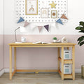 Wooden kids study desk with white lamp, alarm clock, open book and succulent, pastel pink wall with pegboard, framed rainbow prints and bunting