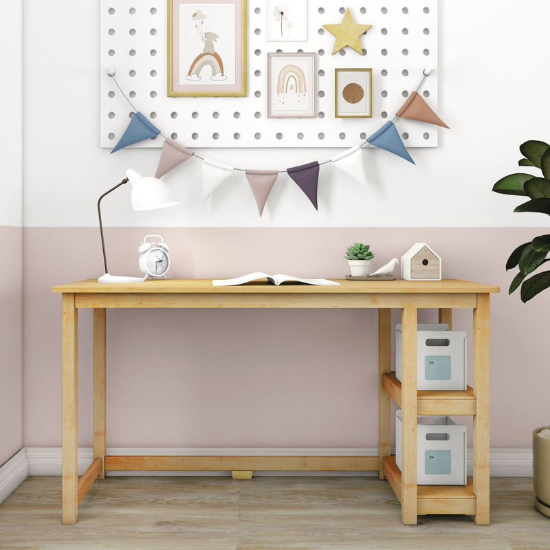 Wooden kids study desk with white lamp, alarm clock, open book and succulent, pastel pink wall with pegboard, framed rainbow prints and bunting
