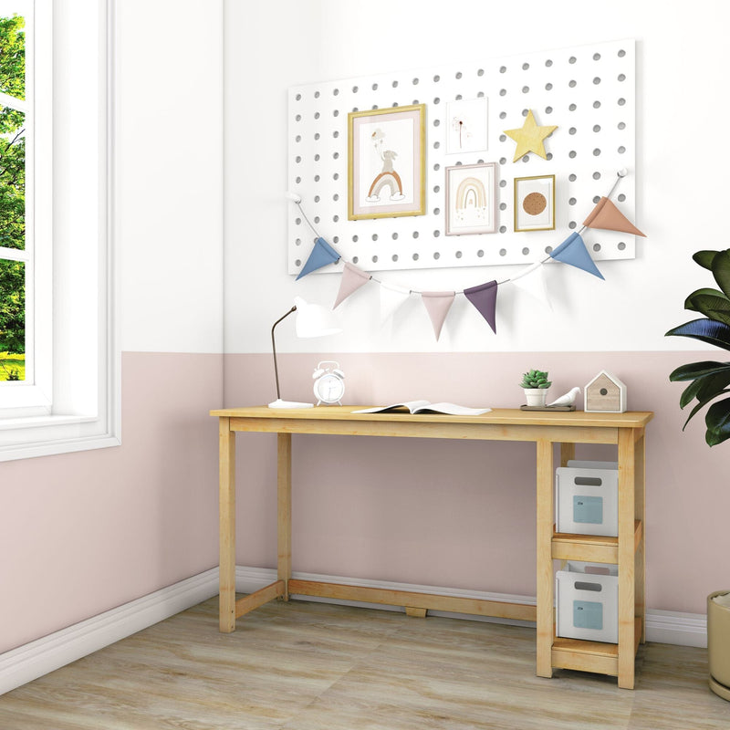 Wooden children's study desk in pastel pink nursery with pegboard gallery wall, rainbow prints, bunting garland, lamp, succulent and storage bins