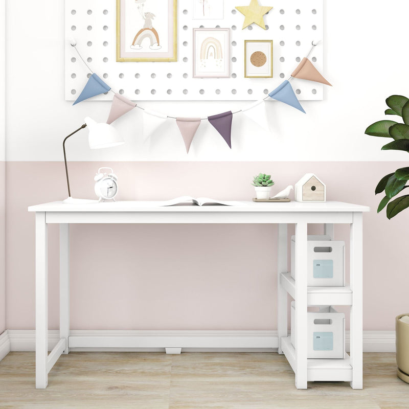 Modern white kids desk with built-in shelves and storage bins in pastel pink nursery, decorated with bunting, desk lamp, alarm clock and succulent