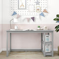 Modern gray kids' study desk with shelves, open book, white lamp, alarm clock and pastel bunting wall decor for a small home office or nursery