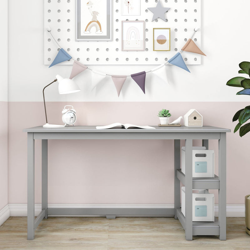 Modern gray kids' study desk with shelves, open book, white lamp, alarm clock and pastel bunting wall decor for a small home office or nursery